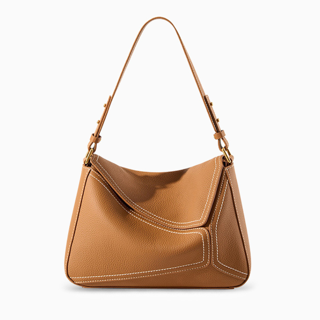 Tan handbag with a shoulder strap on a white background