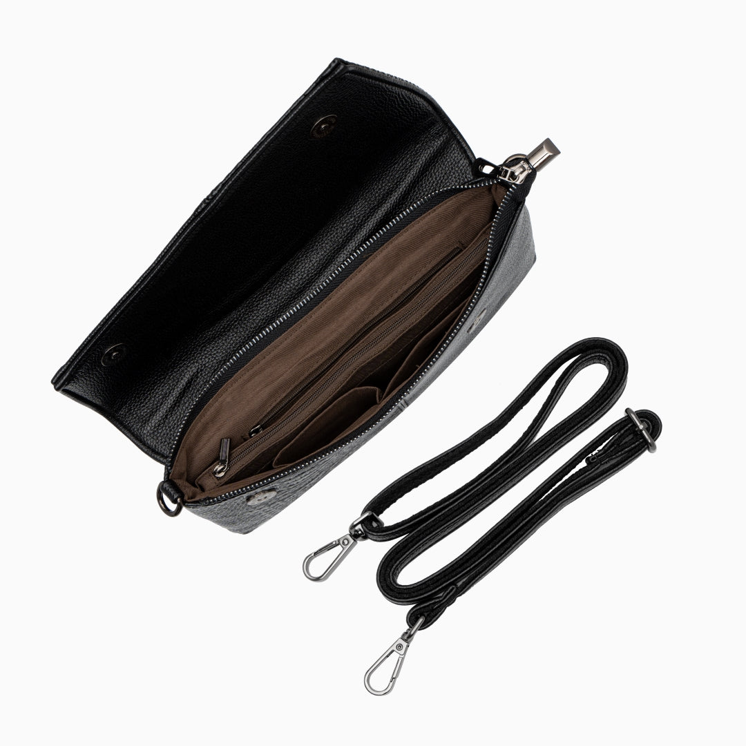 Black leather handbag with a strap on a white background