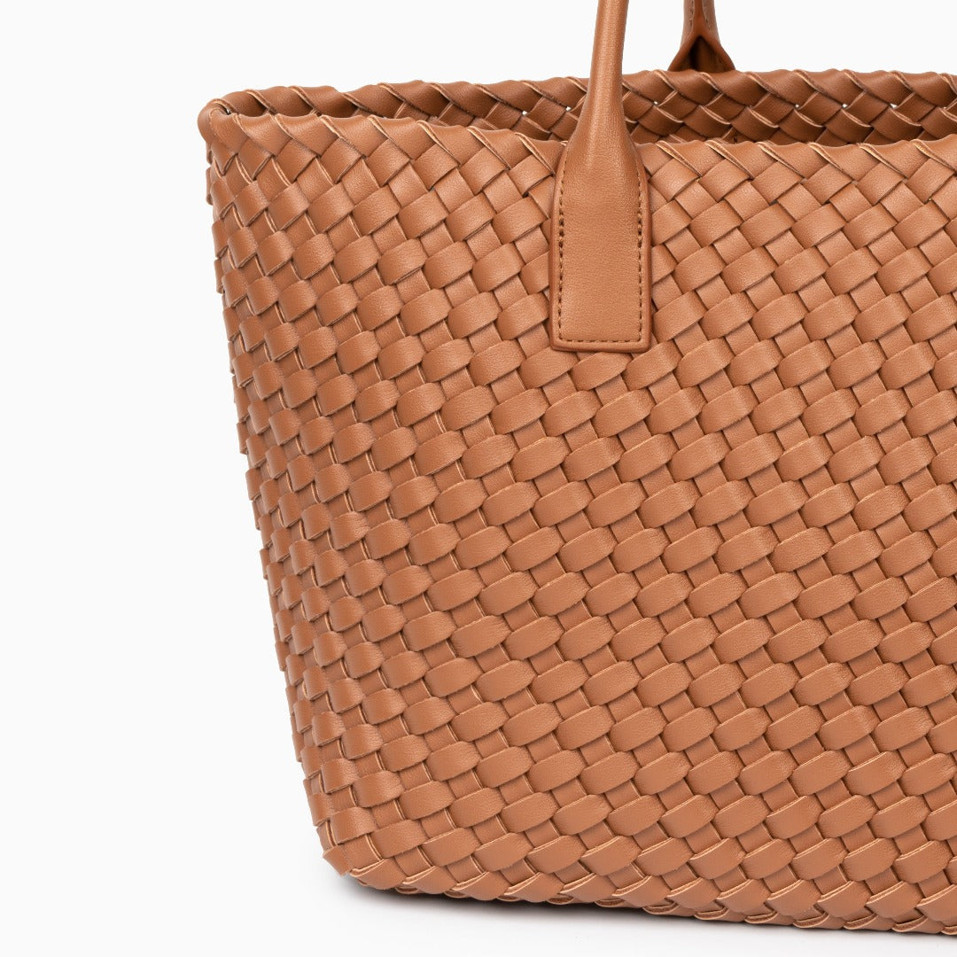 Brown woven handbag on a white background