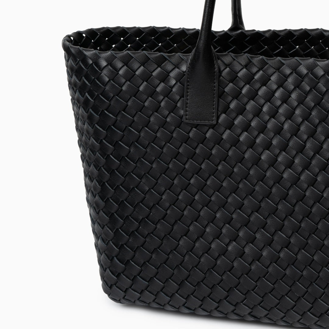Black woven handbag on a white background