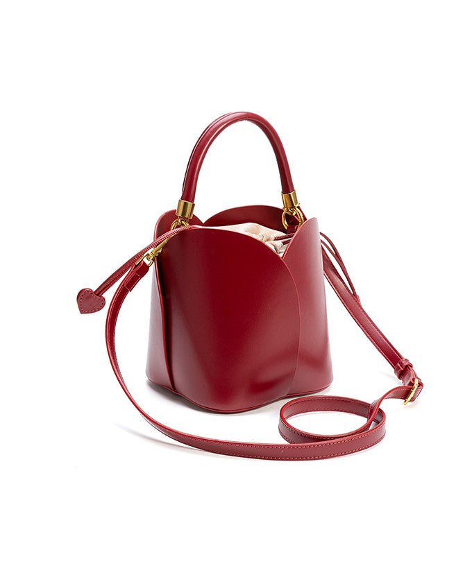 Charming Lily Bucket Handbag in Burgundy featuring a heart-shaped closure. 3