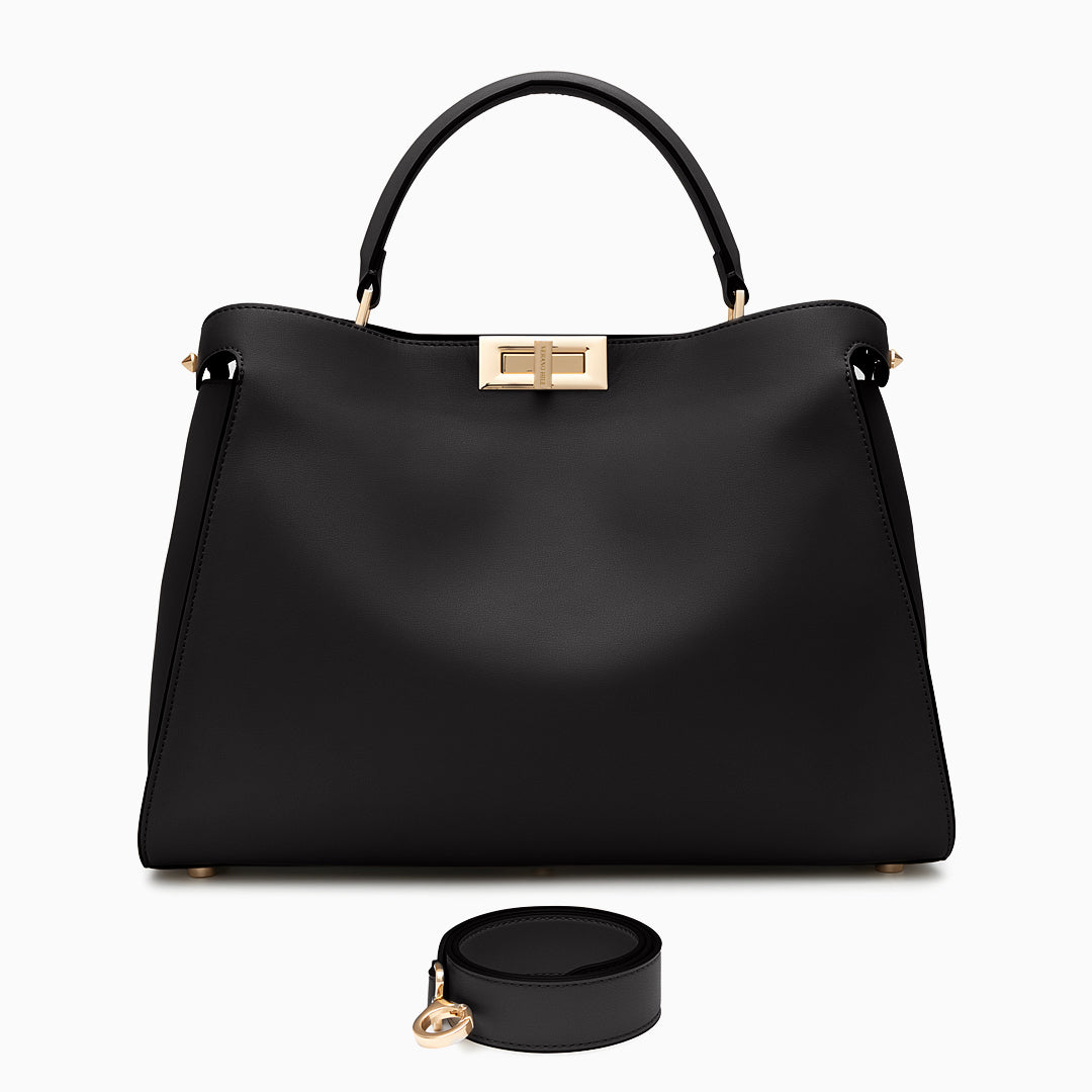 Black handbag with gold hardware on a white background