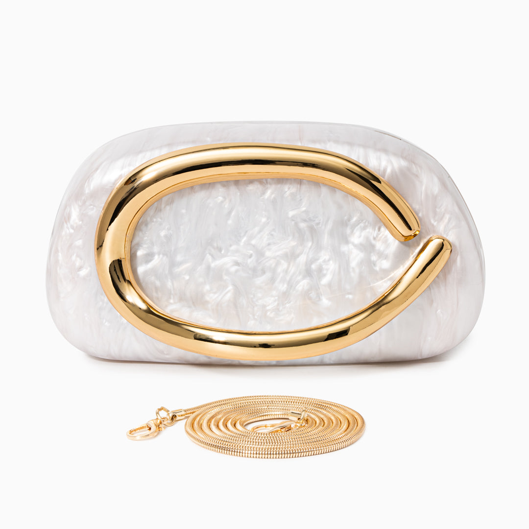 Sculptural gold clutch bag with a pearlescent acrylic finish, designed for elegant evening wear. 6