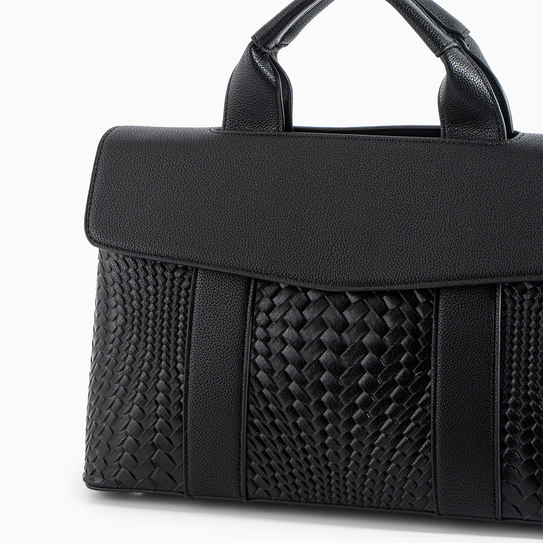 Black handbag with woven pattern on a white background