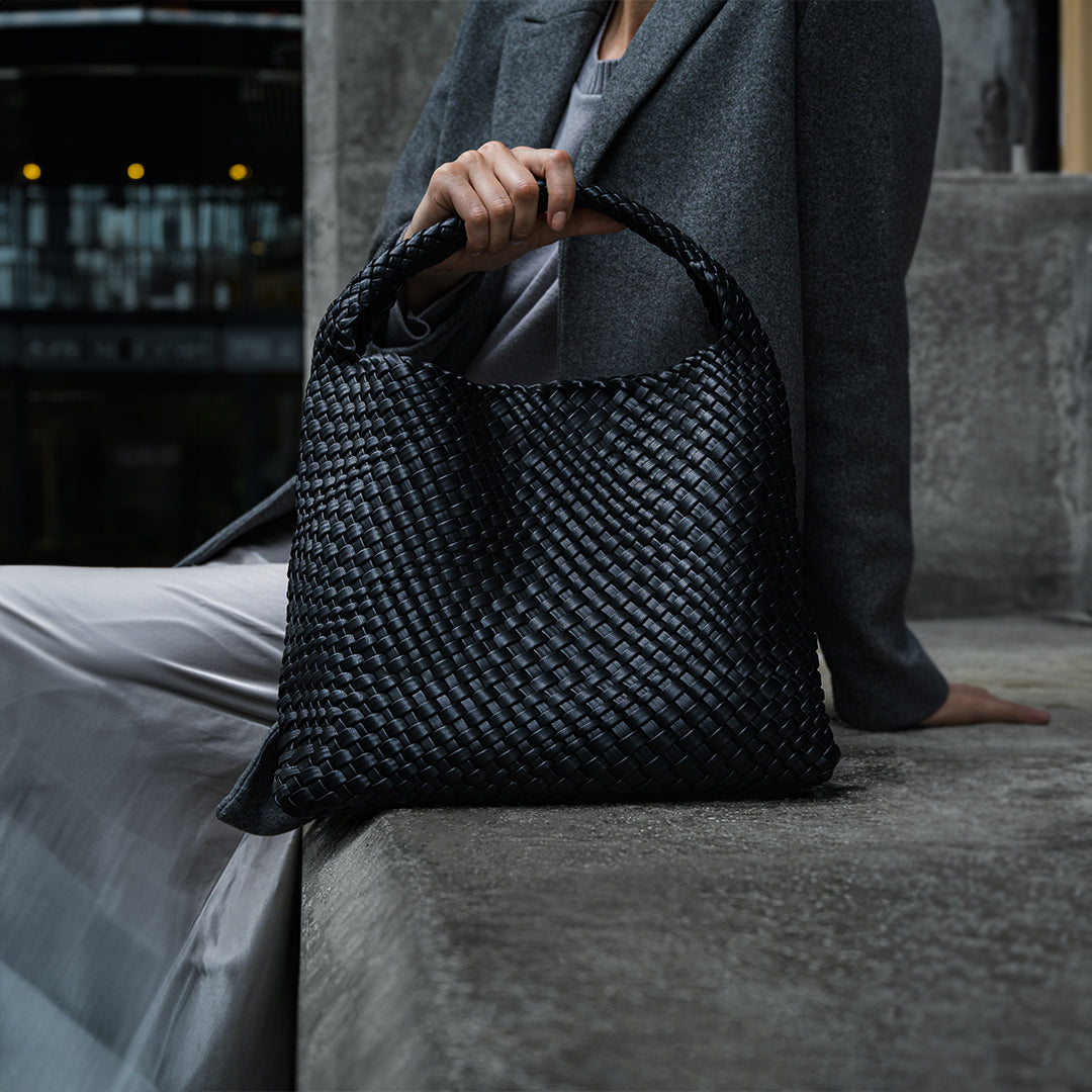 A stylish black vegan leather shoulder bag with a large capacity, featuring a sleek design and elegant details. 5