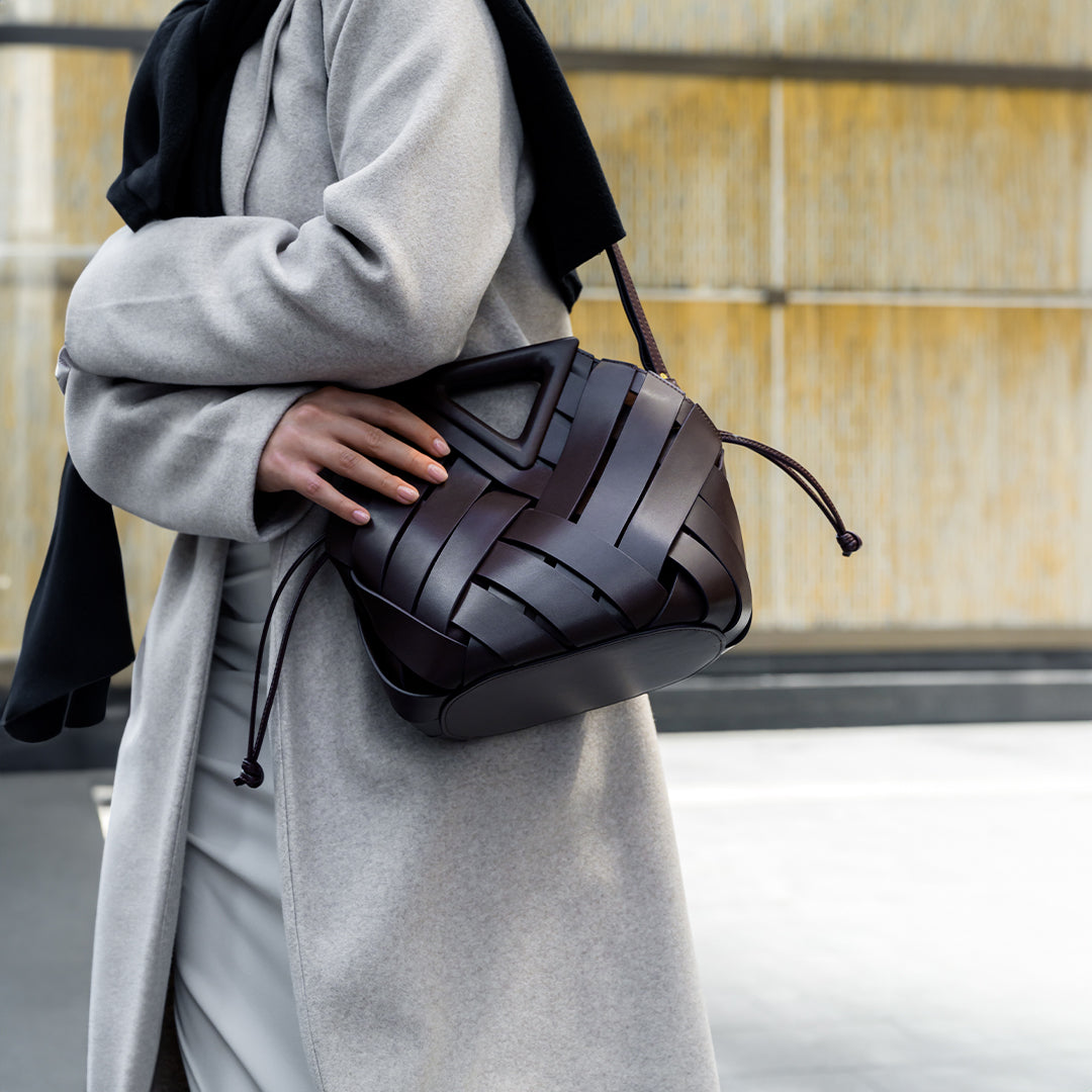 Sophia woven handbag featuring an inverted triangle handle with an elegant fabric design. 4