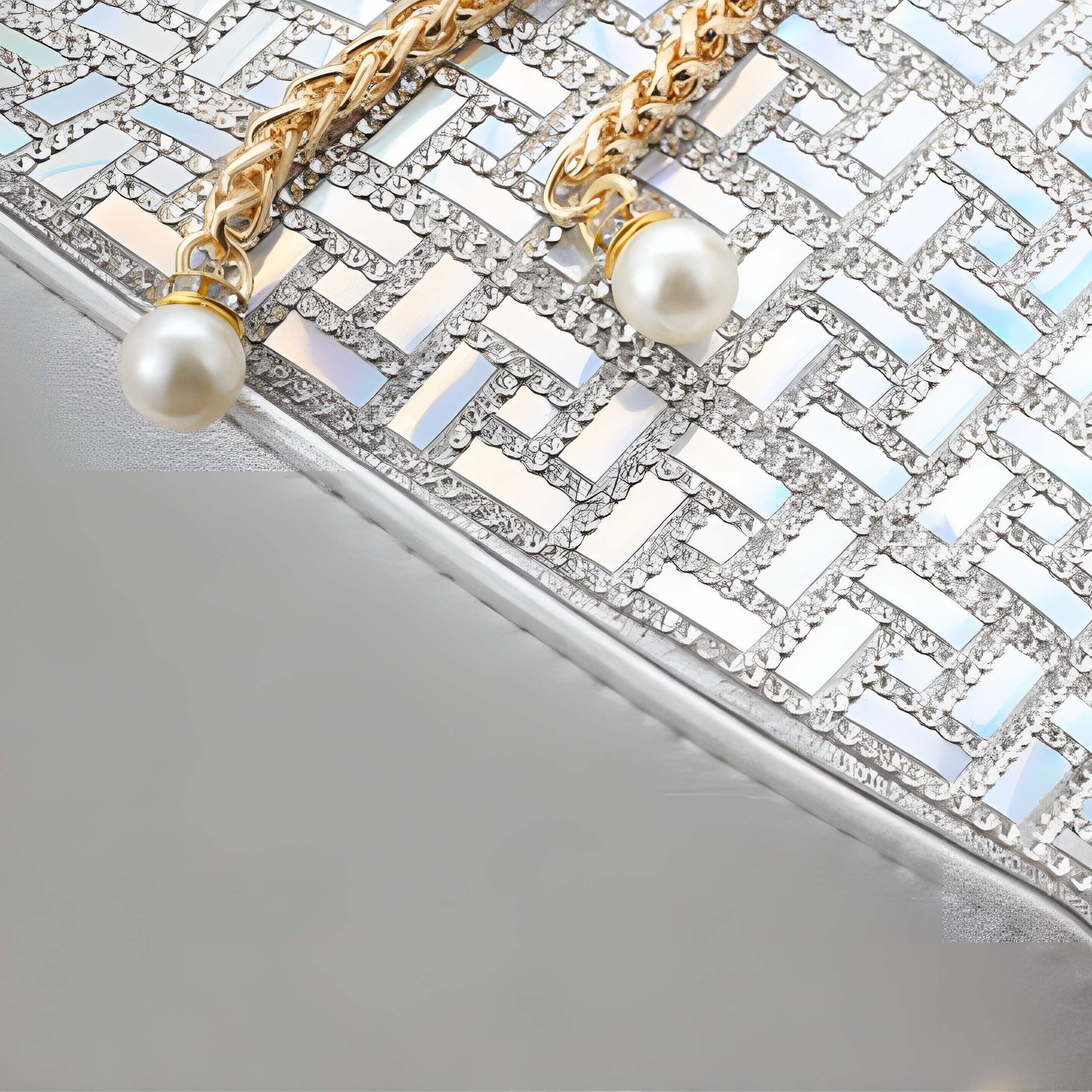 Close-up of a Aurelia handbag with pearls and gold chain on a textured surface