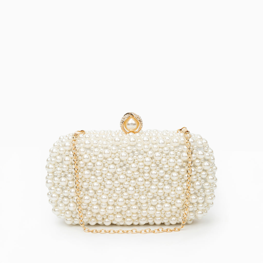 Pearl-handled clutch bag with gold chain on a white background