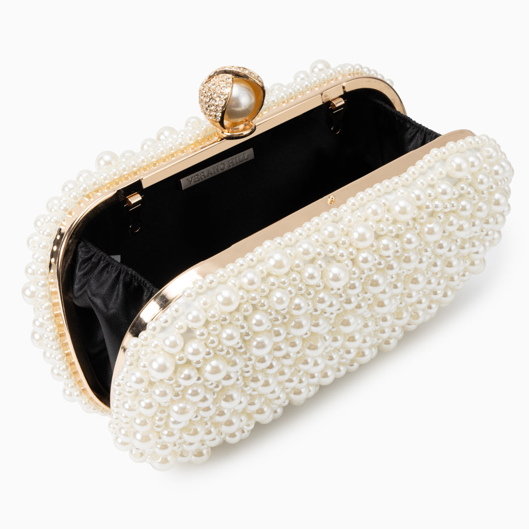 Pearl-embellished clutch bag on a white background