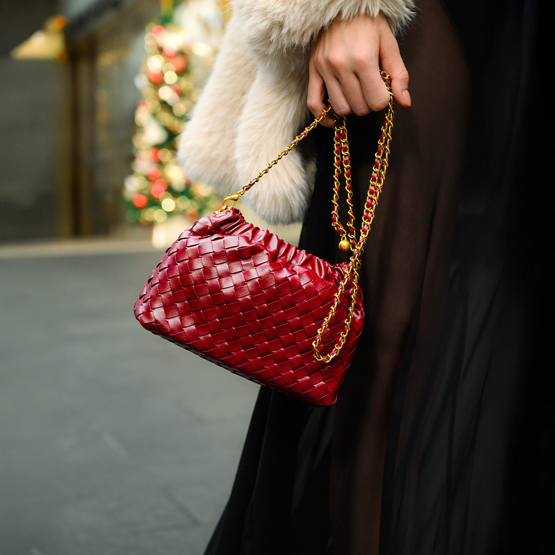 Chic black shoulder bag with a woven design and a gold braided strap. 7