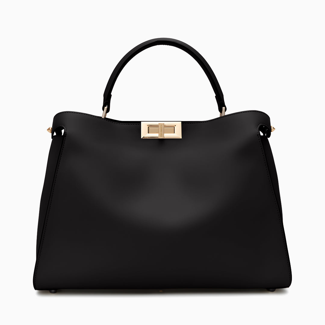 Black handbag with a gold clasp on a white background
