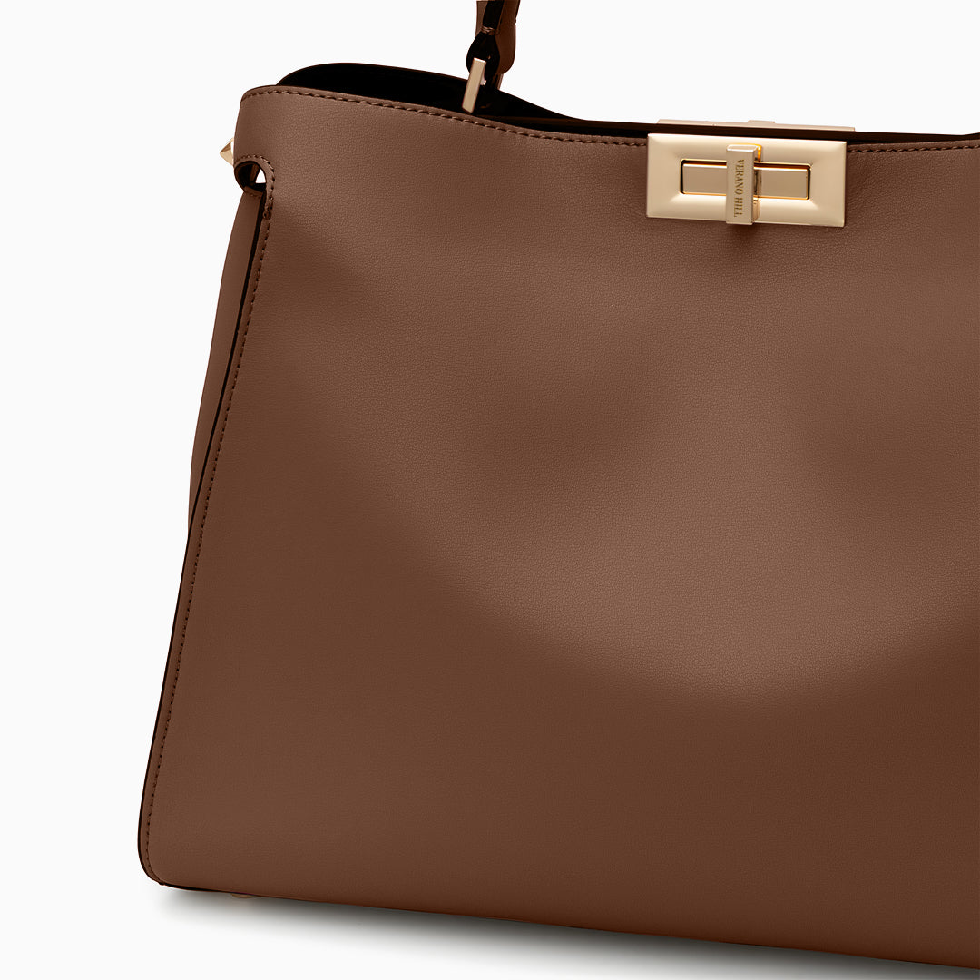 Brown handbag with a gold clasp on a white background