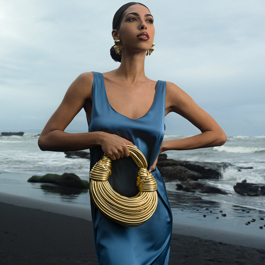 Elegant black vegan leather handbag featuring unique knotted detailing. 4
