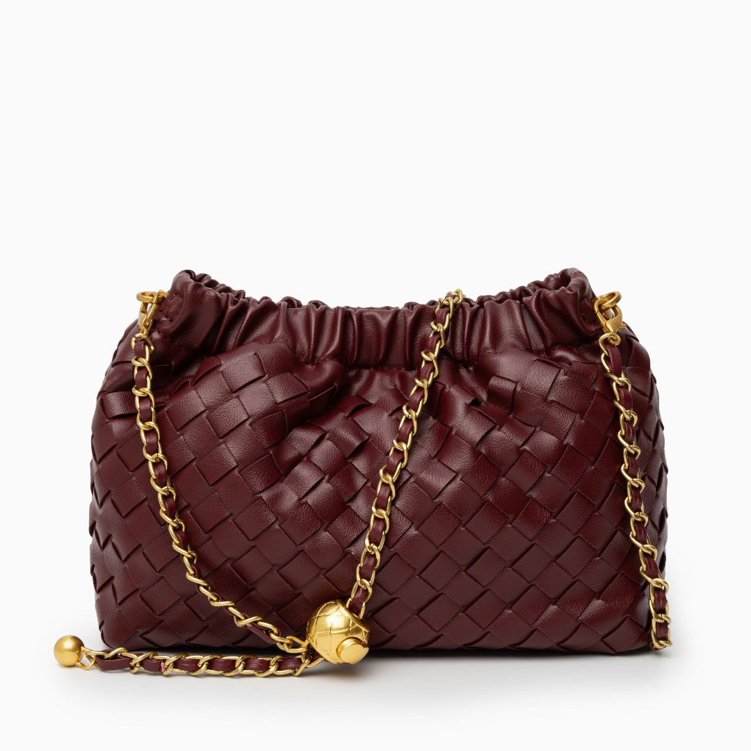 Red woven handbag with gold chain on a white background