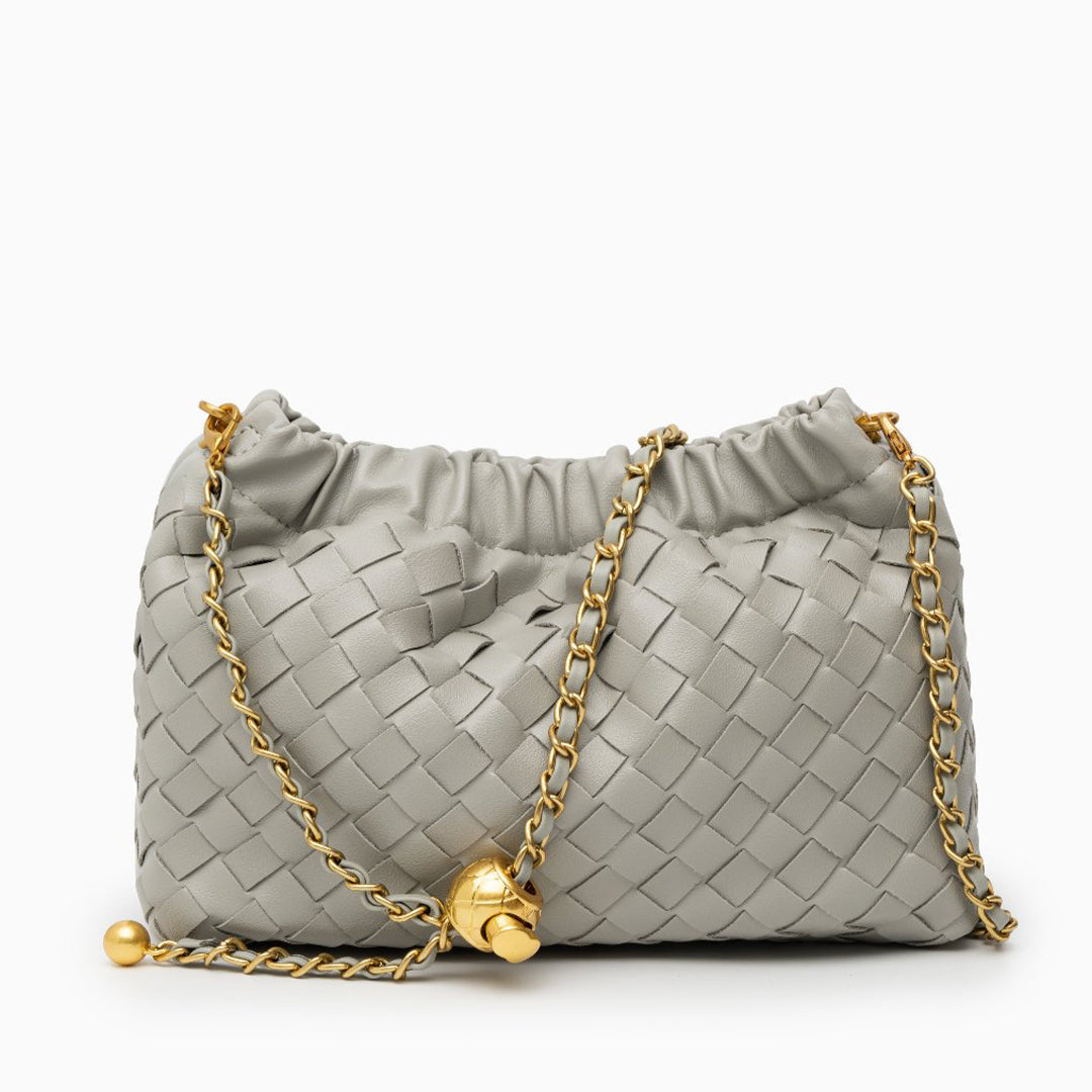Gray handbag with gold chain and clasp on a white background