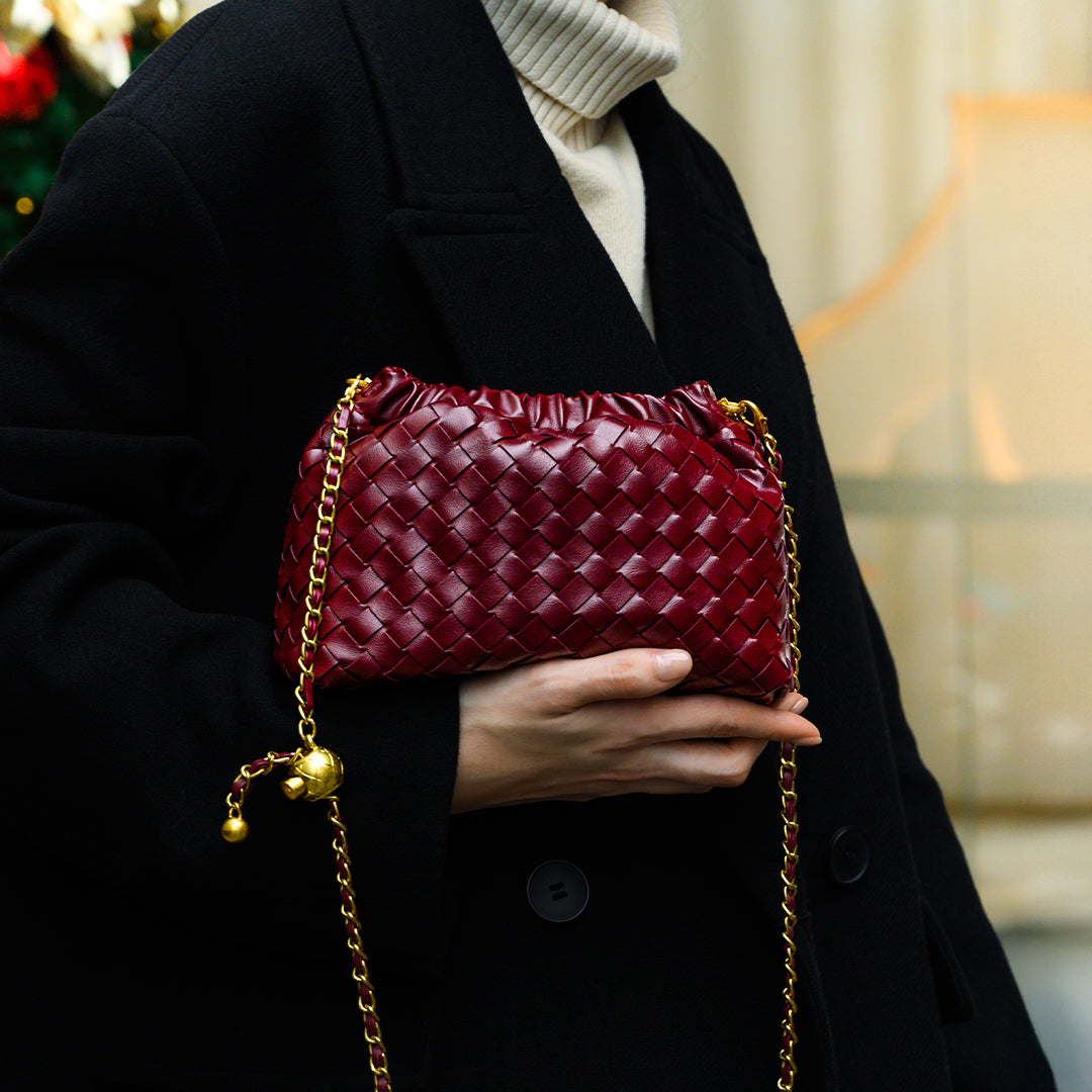 Chic black shoulder bag with a woven texture and a gold braided strap. 3