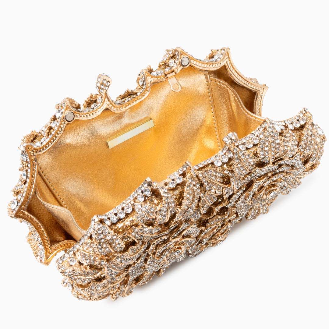 Gold clutch with intricate design inside view on a white background