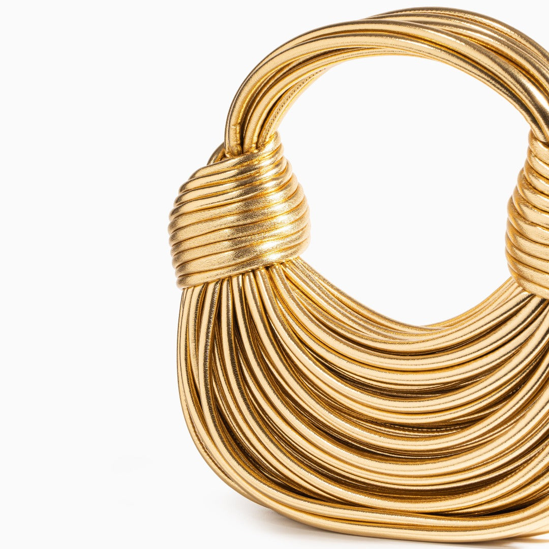 Gold handbag on white background