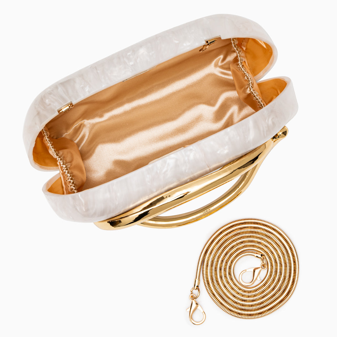 Sculptural gold clutch bag with a pearlescent acrylic finish, designed for elegant evening wear.