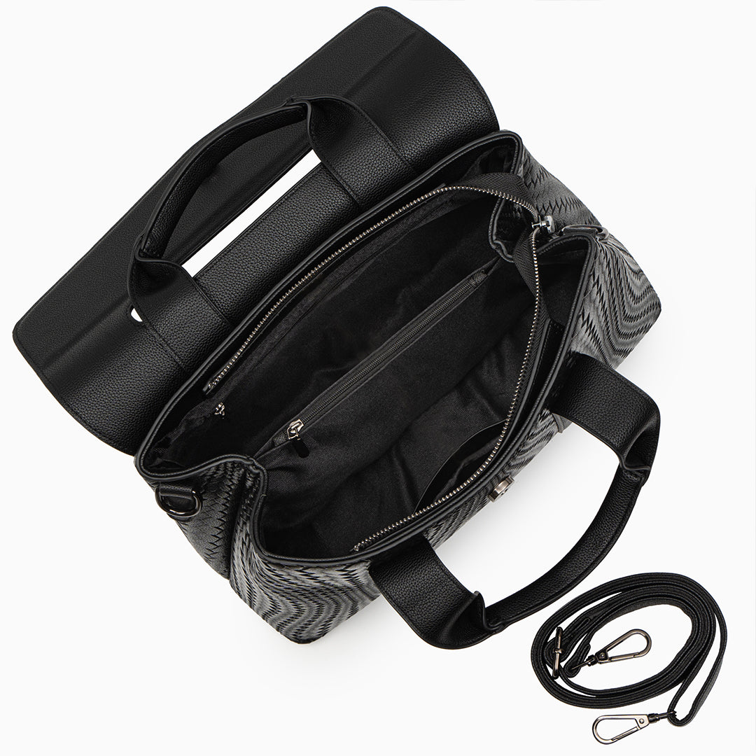 Black leather handbag with a strap on a white background