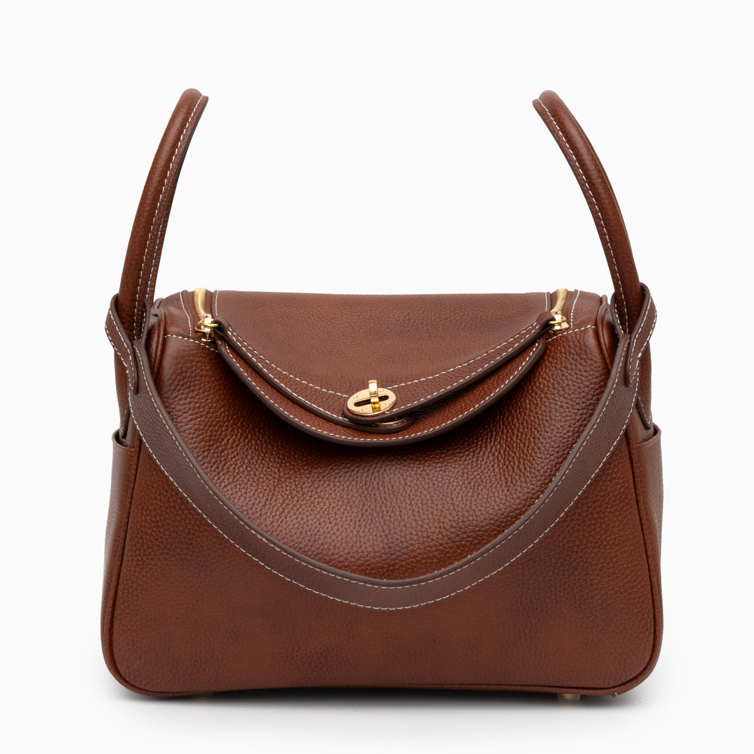 Sophia Luxe Mini Shoulder Bag in black genuine leather with a curved flap design. 0