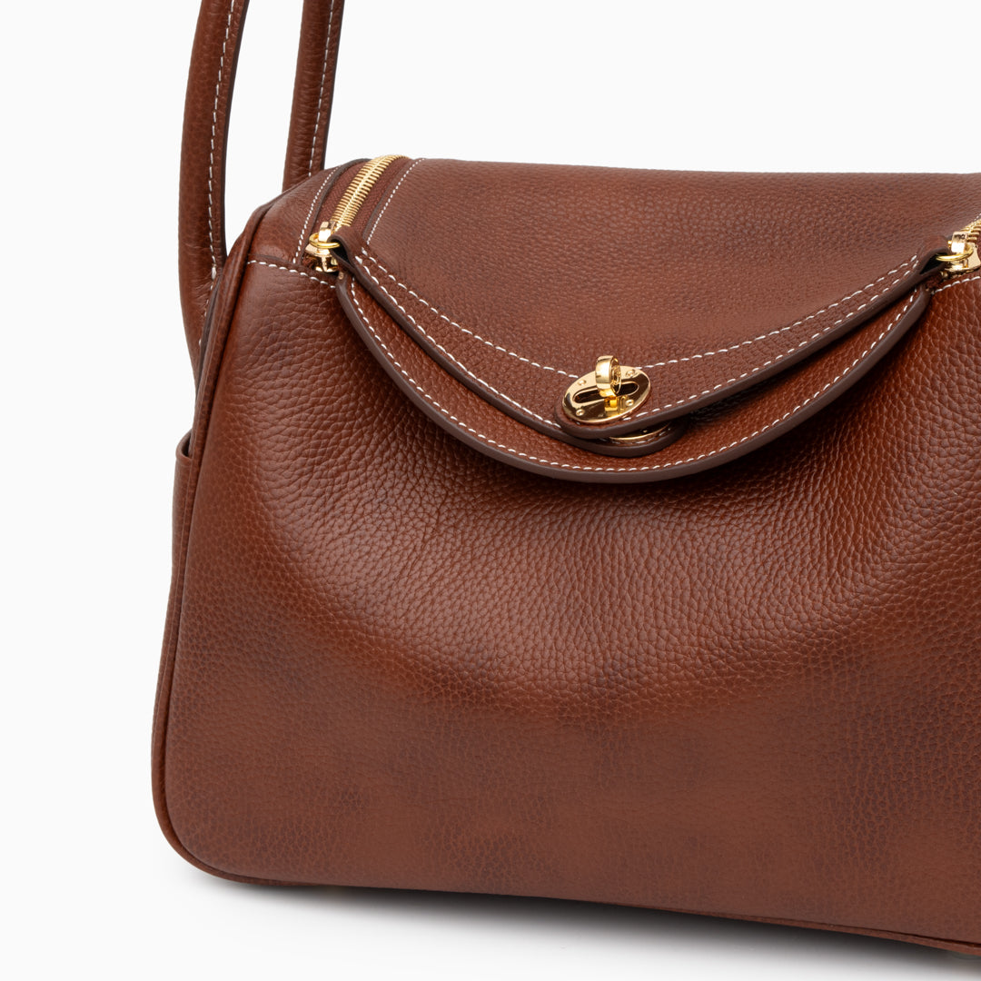 Sophia Luxe Mini Shoulder Bag in black genuine leather with a curved flap design. 1