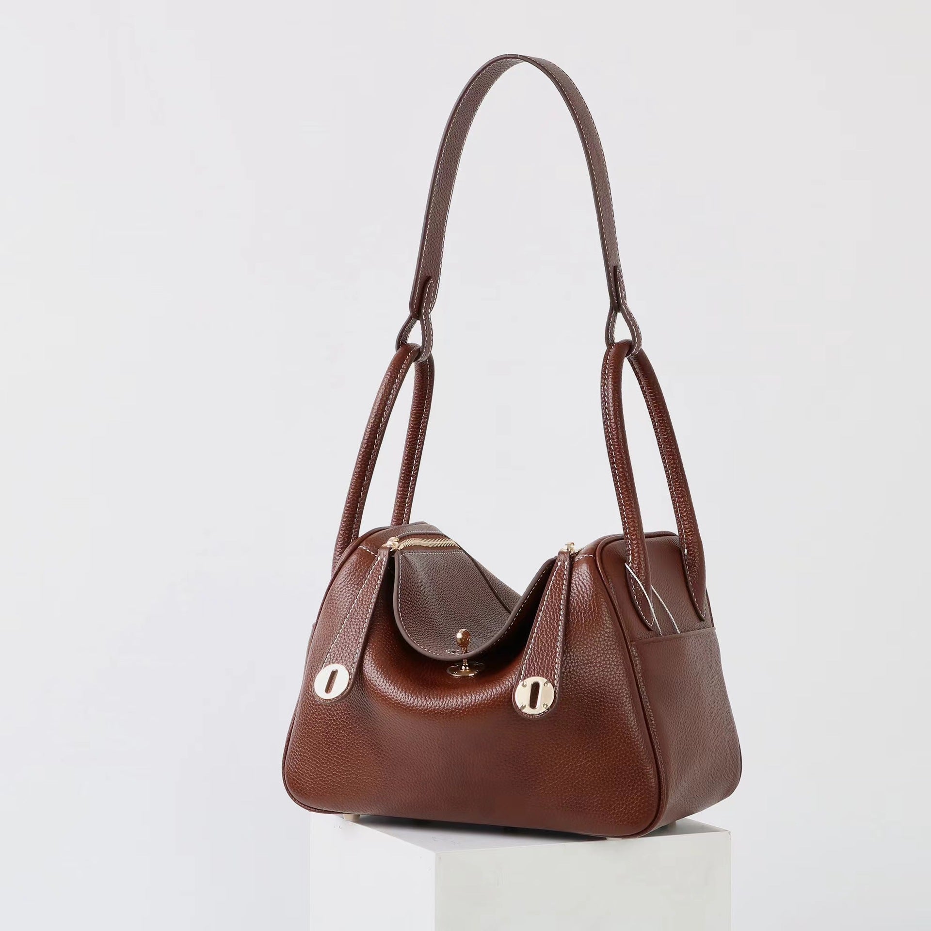 Sophia Luxe Mini Shoulder Bag in black genuine leather with a curved flap design. 2