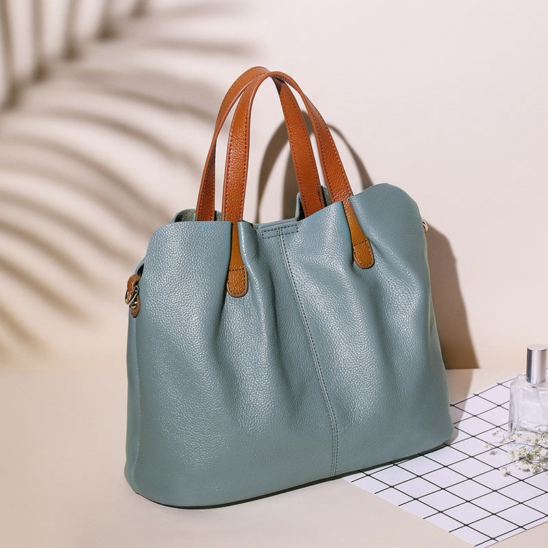A stylish multi-colour leather tote bag with versatile carry options, featuring a sleek design and elegant detailing. 1